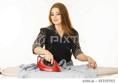 Happy woman doing ironing 48389563