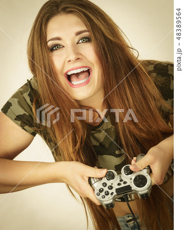 Gamer woman holding gaming pad 48389564
