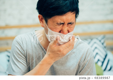 man coughing and suffering in medical mask man coughing and suffering in medical mask 48389987
