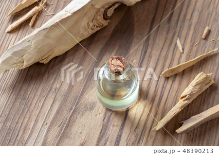 A bottle of white sandalwood essential oil A bottle of white sandalwood essential oil 48390213