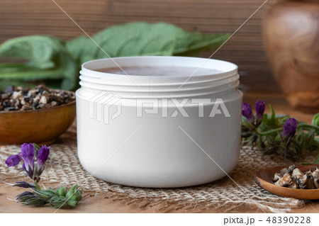 A jar of homemade comfrey root ointment 48390228