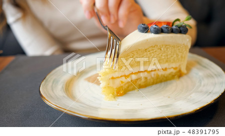 Girl Eating Cheese Cake in the Cafe. 48391795