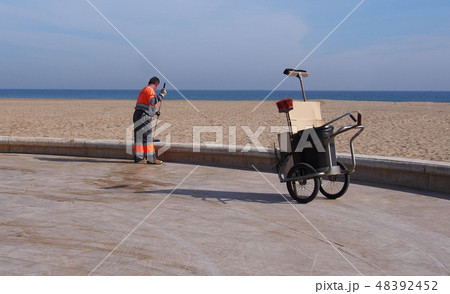 City workers - cleaning and washing of city street City workers - cleaning and washing of city street 48392452