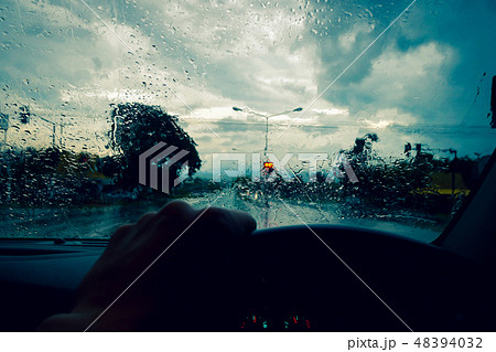 Drive on the road while heavy rain storms,Please be careful when driving in rainy road 48394032
