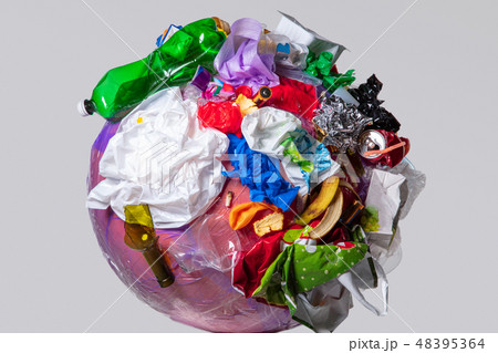 A globe of the earth with trash over white background, the concept of ecology problem A globe of the earth with trash over white background, the concept of ecology problem 48395364