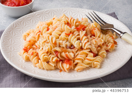Spiral pasta mixed with cherry tomatoes and tomato Spiral pasta mixed with cherry tomatoes and tomato 48396753