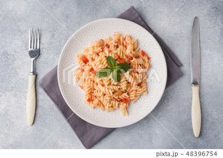 Spiral pasta mixed with cherry tomatoes and tomato Spiral pasta mixed with cherry tomatoes and tomato 48396754