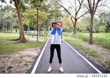 Exercise concept. beautiful girl is exercising in the park. Beau 48397236