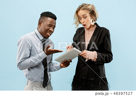 Serious businesswoman and colleague in the office. Serious businesswoman and colleague in the office. 48397527