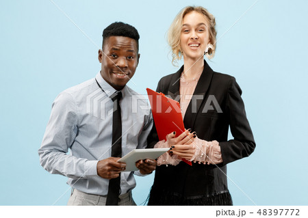 Concept of partnership in business. Young man and woman standing at studio Concept of partnership in business. Young man and woman standing at studio 48397772