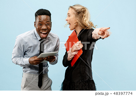 Concept of partnership in business. Young man and woman standing at studio Concept of partnership in business. Young man and woman standing at studio 48397774