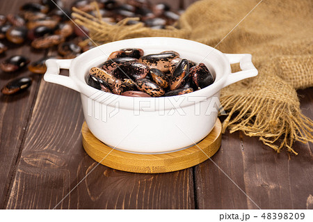 Speckled colored butter beans on brown wood Speckled colored butter beans on brown wood 48398209