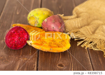 Fresh bright prickly pear opuntia on brown wood 48398715