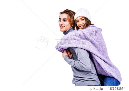 Image of lovely couple having fun while man piggybacking his girlfriend isolated on white background 48398864