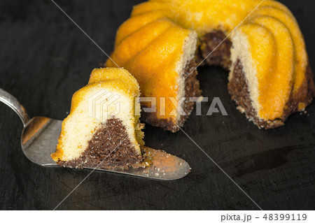 baked marble gugelhupf sweet bread on grey stone 48399119