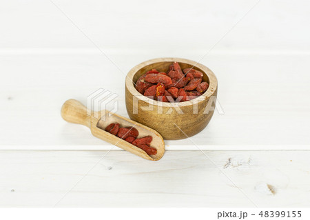 Dried red goji berries on grey wood Dried red goji berries on grey wood 48399155