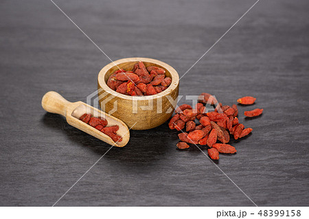 Dried red goji berries on grey stone 48399158