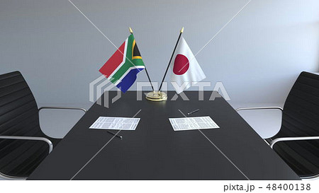 Flags of South Africa and Japan and papers on the table. Negotiations and signing an international 48400138
