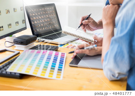 graphic designer team working on web design using color swatches graphic designer team working on web design using color swatches 48401777