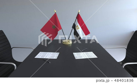 Flags of Morocco and Egypt and papers on the table. Negotiations and signing an international Flags of Morocco and Egypt and papers on the table. Negotiations and signing an international 48401836