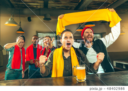 Sport, people, leisure, friendship and entertainment concept - happy football fans or male friends 48402986