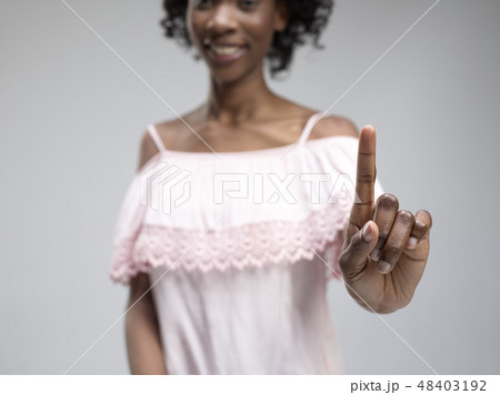 Woman's hand with finger on blue background Woman's hand with finger on blue background 48403192