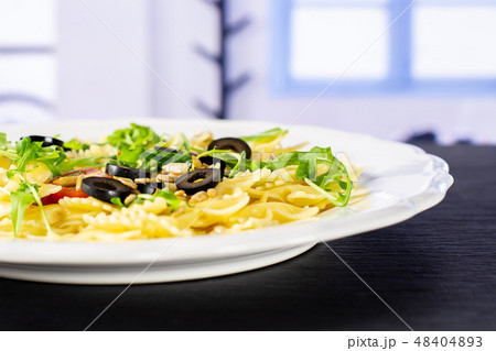 Recipe farfalle with arugula leaves blue window 48404893