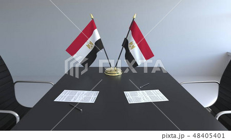 Flags of Egypt and papers on the table. Negotiations and signing an agreement. Conceptual 3D Flags of Egypt and papers on the table. Negotiations and signing an agreement. Conceptual 3D 48405401