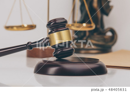 Judge gavel with Justice lawyers having team meeting at law firm in background. Concepts of 48405631