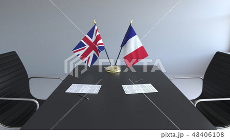 Flags of Great Britain and France and papers on the table. Negotiations and signing an international 48406108
