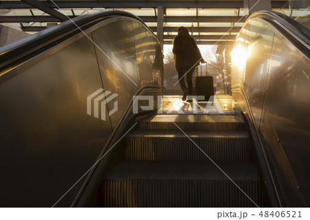 Escalators stairs and woman traveler silhouette Escalators stairs and woman traveler silhouette 48406521