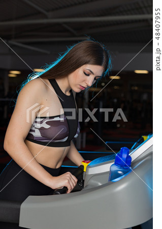 Attractive young sports woman is working out in 48407955