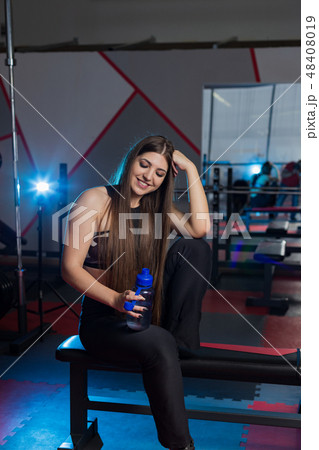 Beautiful sexy fitness model resting after workout Beautiful sexy fitness model resting after workout 48408019