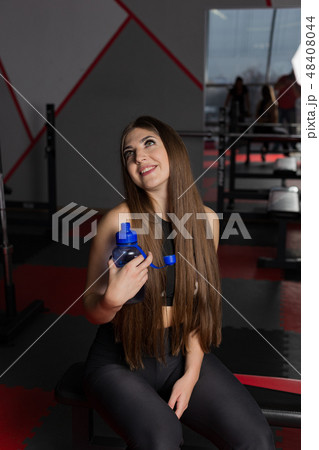 Beautiful sexy fitness model resting after workout 48408044