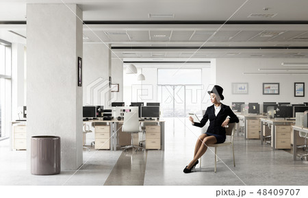 Businesswoman on chair in office 48409707