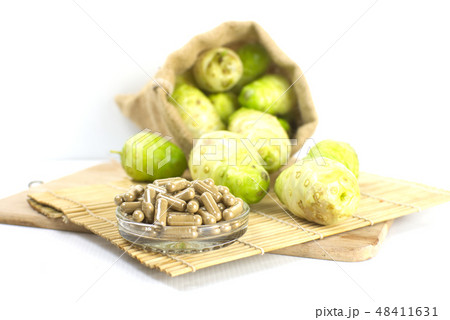 Noni powder capsule with noni fruit .Horizontal Noni powder capsule with noni fruit .Horizontal 48411631