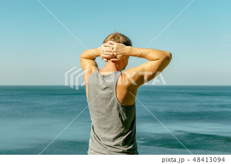 Man enjoying the view and fresh air on the ocean 48413094