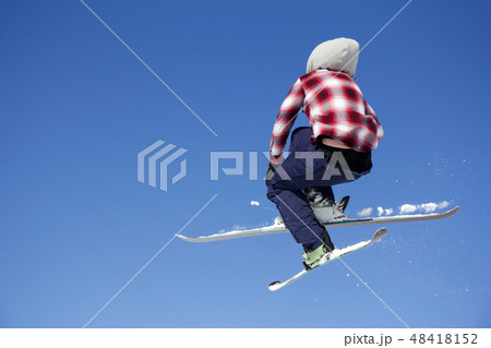 Flying skier at jump inhigh on snowy mountains Flying skier at jump inhigh on snowy mountains 48418152