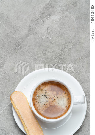 Italian Savoiardi ladyfingers Biscuits and cup of coffee on concrete backgound Italian Savoiardi ladyfingers Biscuits and cup of coffee on concrete backgound 48418688