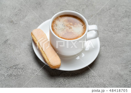 Italian Savoiardi ladyfingers Biscuits and cup of coffee on concrete backgound 48418705