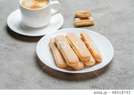 Italian Savoiardi ladyfingers Biscuits and cup of coffee on concrete backgound 48418745