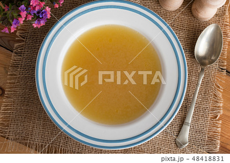 Chicken bone broth served in a soup plate 48418831