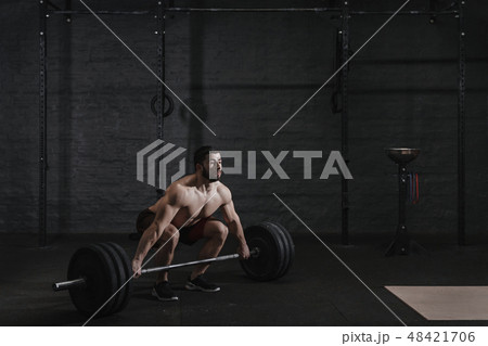 Crossfit athlete doing deadlift exercise Crossfit athlete doing deadlift exercise 48421706