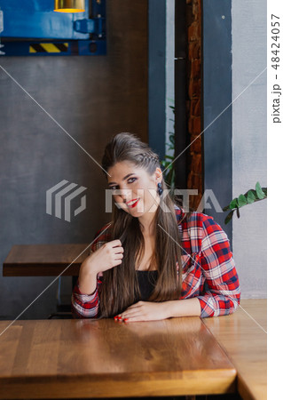 Beautiful and sexy girl sitting by the window in a 48424057