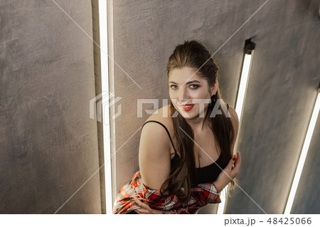 Beautiful and sexy girl posing for a photographer Beautiful and sexy girl posing for a photographer 48425066