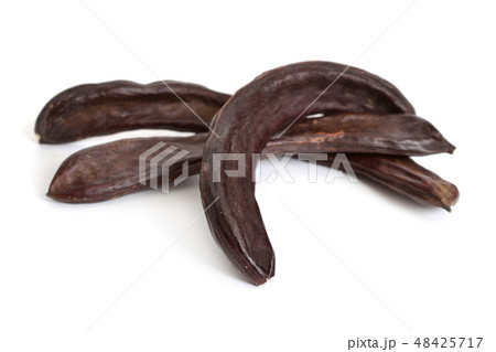 Carob pods isolated on white background Carob pods isolated on white background 48425717