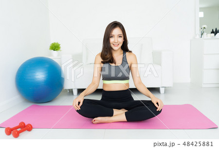 Health concept. Attractive young Asian woman sitting on mat  pra 48425881