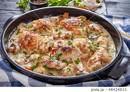 hot chicken fricassee in a black dutch oven 48426623