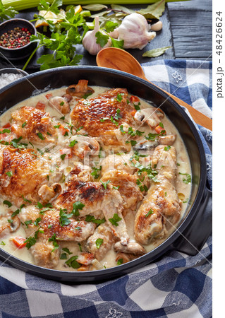 hot chicken fricassee in a black dutch oven 48426624