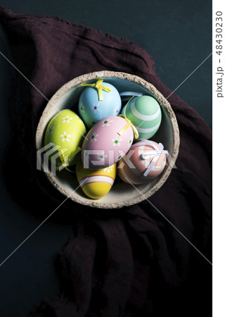 decorated Easter eggs in a ceramic bowl 48430230